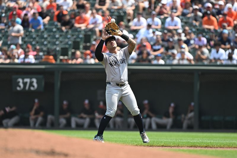 Jul 14, 2024; Baltimore, Maryland, USA;  New York Yankees second base Gleyber Torres (25) makes a catch during the first inning against the Baltimore Orioles at Oriole Park at Camden Yards. Mandatory Credit: James A. Pittman-USA TODAY Sports