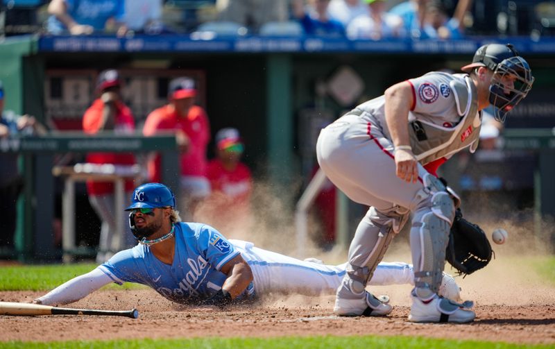 May 28, 2023; Kansas City, Missouri, USA; Kansas City Royals right fielder MJ Melendez (1) slides into home to score the winning run ahead of the throw to Washington Nationals catcher Riley Adams (15) during the ninth inning at Kauffman Stadium. Mandatory Credit: Jay Biggerstaff-USA TODAY Sports