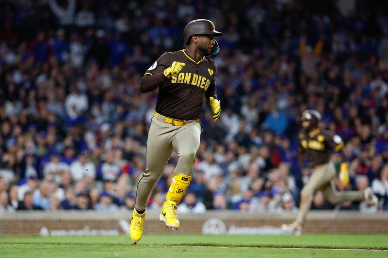 May 6, 2024; Chicago, Illinois, USA; San Diego Padres outfielder Jurickson Profar (10) runs to first base after hitting a two-run single against the Chicago Cubs during the sixth inning at Wrigley Field. Mandatory Credit: Kamil Krzaczynski-USA TODAY Sports