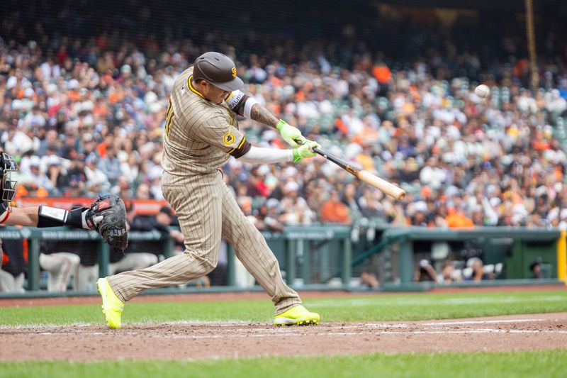 Sep 15, 2024; San Francisco, California, USA; San Diego Padres designated hitter Manny Machado (21) drives in a run during the sixth inning against the San Francisco Giants at Oracle Park. Mandatory Credit: Bob Kupbens-Imagn Images