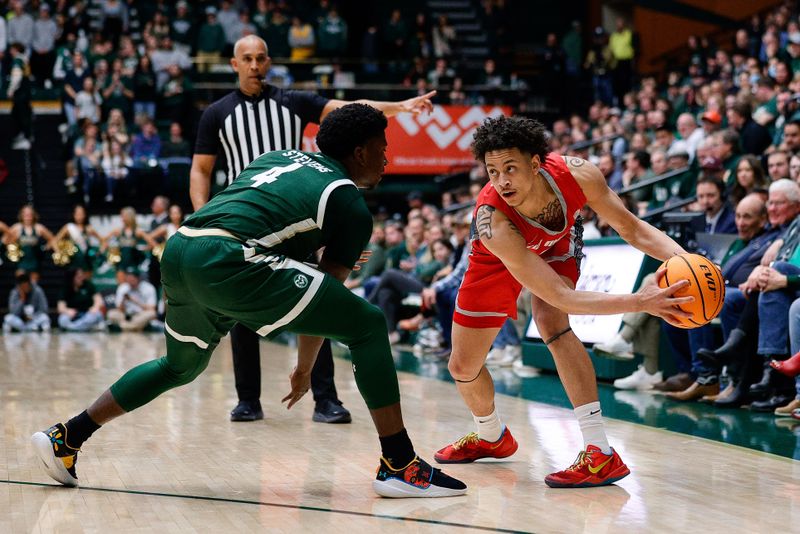 Mar 3, 2023; Fort Collins, Colorado, USA; New Mexico Lobos guard KJ Jenkins (0) controls the ball as Colorado State Rams guard Isaiah Stevens (4) guards in the first half at Moby Arena. Mandatory Credit: Isaiah J. Downing-USA TODAY Sports