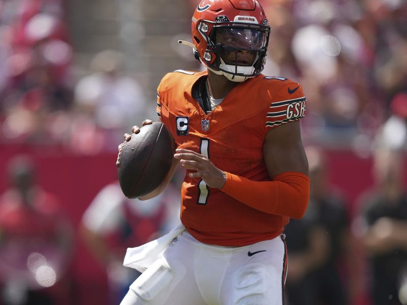 Chicago Bears quarterback Justin Fields (1) looks for an open receiver from the pocket during an NFL preseason football game against the Tampa Bay Buccaneers, Sunday, Sept. 17, 2023, in Tampa, Fla. (AP Photo/Peter Joneleit)