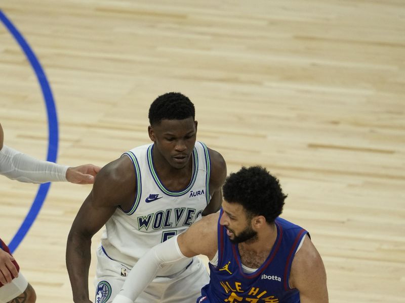 MINNEAPOLIS, MN -  MAY 16: Jamal Murray #27 of the Denver Nuggets handles the ball against Anthony Edwards #5 of the Minnesota Timberwolves during the game during Round 2 Game 6 of the 2024 NBA Playoffs on May 16, 2024 at Target Center in Minneapolis, Minnesota. NOTE TO USER: User expressly acknowledges and agrees that, by downloading and or using this Photograph, user is consenting to the terms and conditions of the Getty Images License Agreement. Mandatory Copyright Notice: Copyright 2024 NBAE (Photo by Jordan Johnson/NBAE via Getty Images)