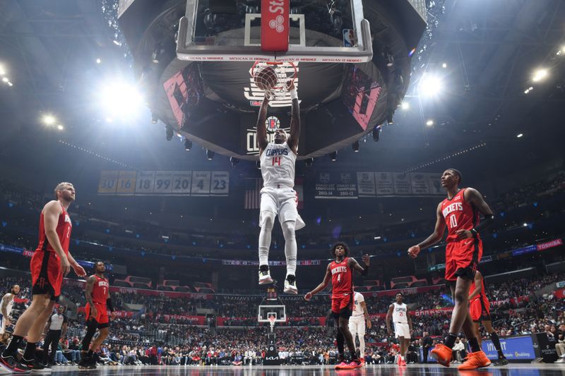 LOS ANGELES, CA - APIRL 14: Terance Mann #14 of the LA Clippers dunks the ball during the game against the Houston Rockets on April 14, 2024 at Crypto.Com Arena in Los Angeles, California. NOTE TO USER: User expressly acknowledges and agrees that, by downloading and/or using this Photograph, user is consenting to the terms and conditions of the Getty Images License Agreement. Mandatory Copyright Notice: Copyright 2024 NBAE (Photo by Adam Pantozzi/NBAE via Getty Images)