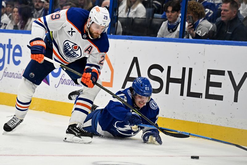 Feb 25, 2025; Tampa, Florida, USA; Tampa Bay Lightning right wing Cam Atkinson (13) and Edmonton Oilers center Leon Draisaitl (29) chase down the puck in the third period at Amalie Arena. Mandatory Credit: Jonathan Dyer-Imagn Images