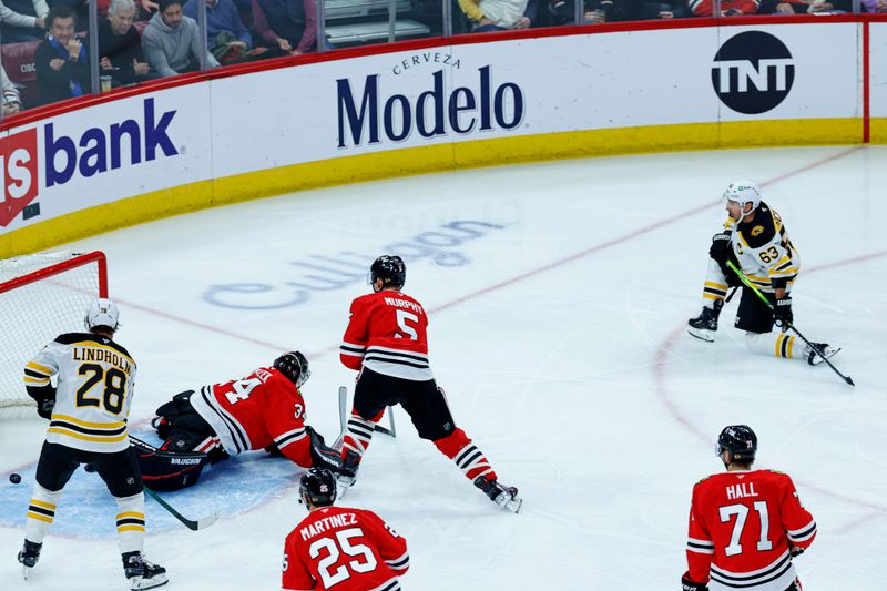 Dec 4, 2024; Chicago, Illinois, USA; Boston Bruins left wing Brad Marchand (63) scores against the Chicago Blackhawks during the second period at United Center. Mandatory Credit: Kamil Krzaczynski-Imagn Images