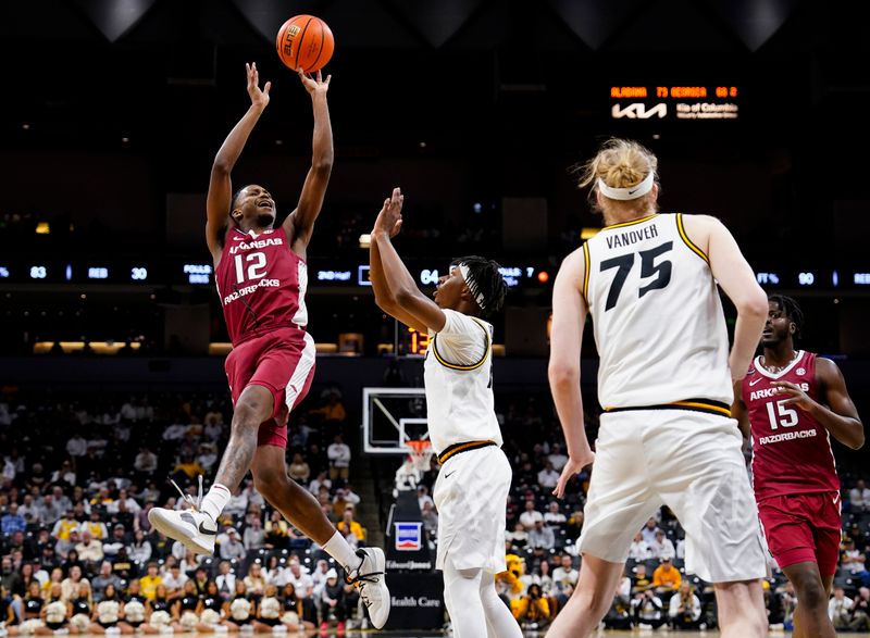 Jan 31, 2024; Columbia, Missouri, USA; Arkansas Razorbacks guard Tramon Mark (12) shoots against Missouri Tigers guard Anthony Robinson II (14) during the second half at Mizzou Arena. Mandatory Credit: Jay Biggerstaff-USA TODAY Sports