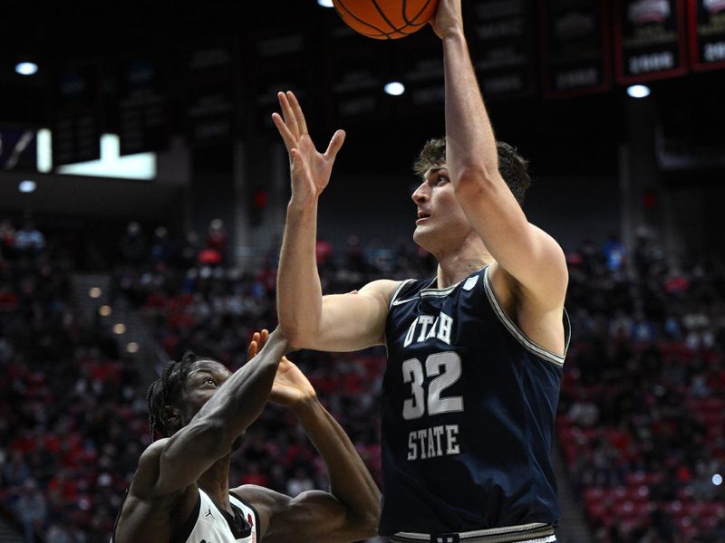 Jan 25, 2023; San Diego, California, USA; Utah State Aggies center Trevin Dorius (32) shoots the ball over San Diego State Aztecs forward Nathan Mensah (31) during the second half at Viejas Arena. Mandatory Credit: Orlando Ramirez-USA TODAY Sports