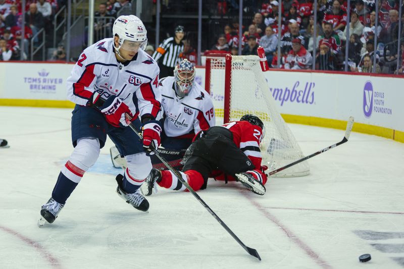 Nov 30, 2024; Newark, New Jersey, USA; Washington Capitals defenseman Martin Fehervary (42) goes for the puck after a shot by the New Jersey Devils during the second period at Prudential Center. Mandatory Credit: Thomas Salus-Imagn Images