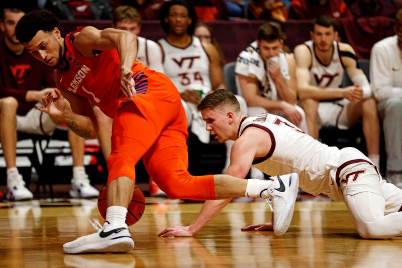 Jan 10, 2024; Blacksburg, Virginia, USA; Clemson Tigers guard Chase Hunter (1) and Virginia Tech Hokies guard Sean Pedulla (3) go for a loose ball during the second half at Cassell Coliseum. Mandatory Credit: Peter Casey-USA TODAY Sports