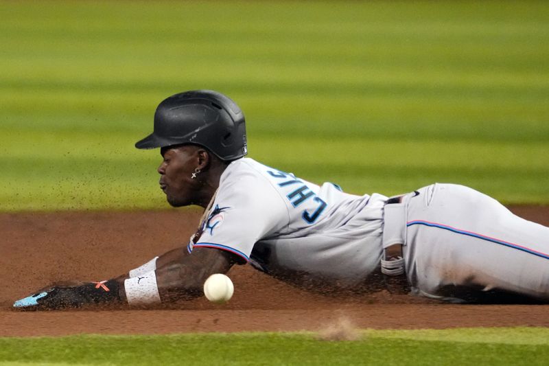 May 9, 2023; Phoenix, Arizona, USA; Miami Marlins center fielder Jazz Chisholm Jr. (2) slides into second base for a steal against the Arizona Diamondbacks during the fifth inning at Chase Field. Mandatory Credit: Joe Camporeale-USA TODAY Sports