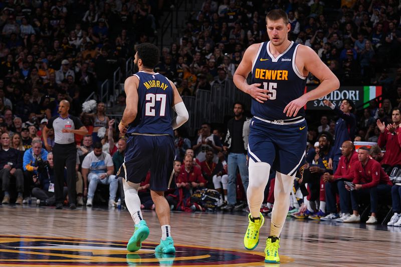 DENVER, CO - APRIL 10: Jamal Murray #27 of the Denver Nuggets and Nikola Jokic #15 look on during the game against the Minnesota Timberwolves on April 10, 2024 at the Ball Arena in Denver, Colorado. NOTE TO USER: User expressly acknowledges and agrees that, by downloading and/or using this Photograph, user is consenting to the terms and conditions of the Getty Images License Agreement. Mandatory Copyright Notice: Copyright 2024 NBAE (Photo by Bart Young/NBAE via Getty Images)