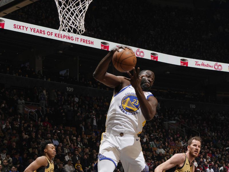 TORONTO, CANADA - MARCH 1:  Draymond Green #23 of the Golden State Warriors grabs the rebound during the game on March 1, 2024 at the Scotiabank Arena in Toronto, Ontario, Canada.  NOTE TO USER: User expressly acknowledges and agrees that, by downloading and or using this Photograph, user is consenting to the terms and conditions of the Getty Images License Agreement.  Mandatory Copyright Notice: Copyright 2024 NBAE (Photo by Mark Blinch/NBAE via Getty Images)