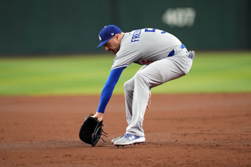 May 10, 2025; Phoenix, Arizona, USA; Los Angeles Dodgers first base Freddie Freeman (5) fields a ground ball against the Arizona Diamondbacks during the second inning at Chase Field. Mandatory Credit: Joe Camporeale-Imagn Images