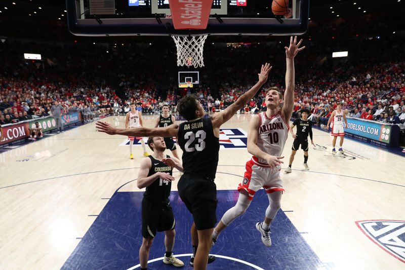 Feb 18, 2023; Tucson, Arizona, USA; Arizona Wildcats forward Azuolas Tubelis (10) makes a basket against Colorado Buffaloes forward Tristan da Silva (23) and guard Ethan Wright (14) during the first half at McKale Center. Mandatory Credit: Zachary BonDurant-USA TODAY Sports