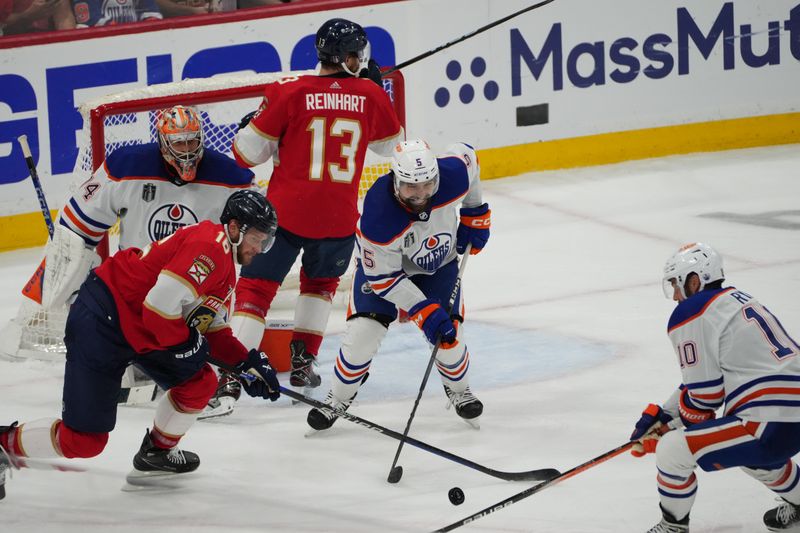 Jun 24, 2024; Sunrise, Florida, USA; Edmonton Oilers defenseman Cody Ceci (5) looks on after blocking a shot on net as Florida Panthers forward Aleksander Barkov (16) reaches for the puck during the third period in game seven of the 2024 Stanley Cup Final at Amerant Bank Arena. Mandatory Credit: Jim Rassol-USA TODAY Sports