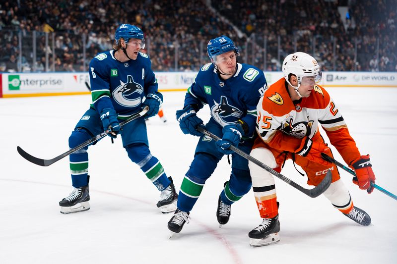 Mar 24, 2026; Vancouver, British Columbia, CAN; Vancouver Canucks forward Brock Boeser (6) watches as forward Marco Rossi (93) checks Anaheim Ducks forward Ryan Poehling (25) in the first period at Rogers Arena. Mandatory Credit: Bob Frid-Imagn Images