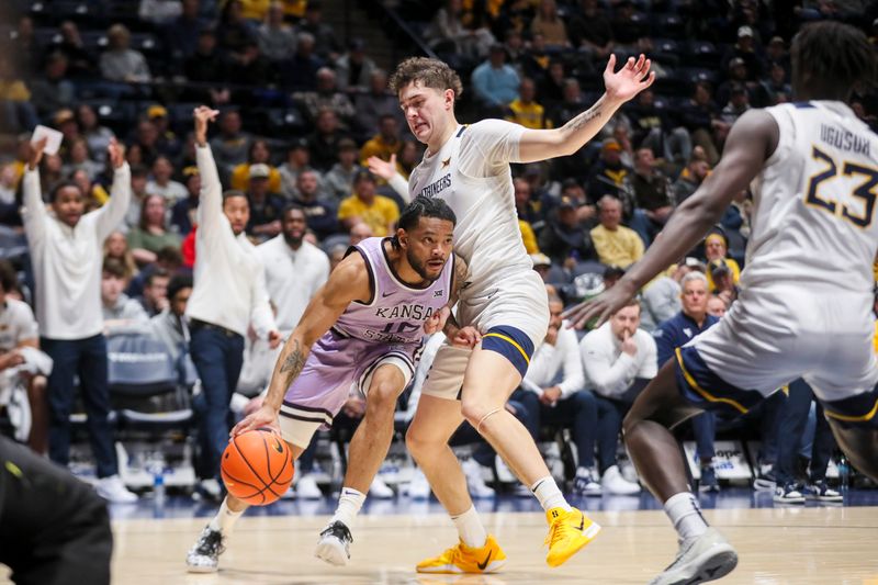 Jan 27, 2026; Morgantown, West Virginia, USA; Kansas State Wildcats guard David Castillo (10) drives baseline against West Virginia Mountaineers guard Treysen Eaglestaff (52) during the first half at Hope Coliseum. Mandatory Credit: Ben Queen-Imagn Imagesa