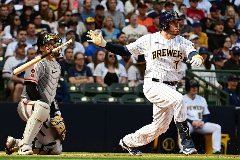 May 27, 2023; Milwaukee, Wisconsin, USA; Milwaukee Brewers catcher Victor Caratini (7) hits a RBI single in the seventh inning during game against the San Francisco Giants at American Family Field. Mandatory Credit: Benny Sieu-USA TODAY Sports