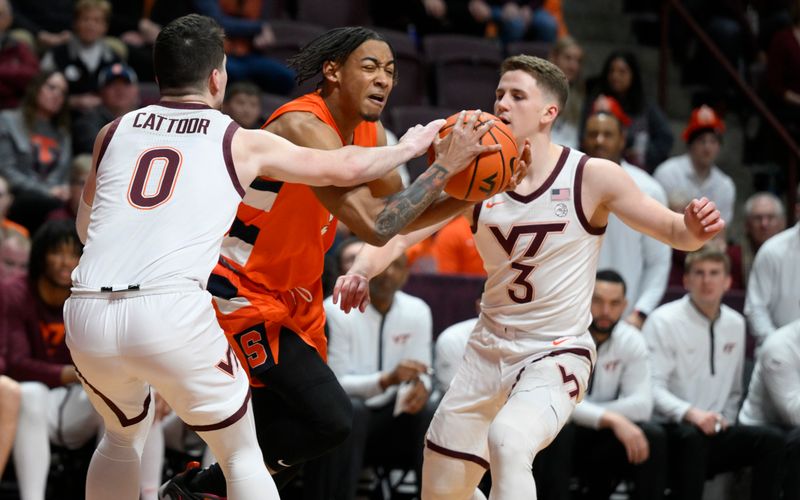 Jan 28, 2023; Blacksburg, Virginia, USA; Syracuse Orange guard Judah Mintz (3) is defended by Virginia Tech Hokies guard Hunter Cattoor (0) and guard Sean Pedulla (3) in the first half at Cassell Coliseum. Mandatory Credit: Lee Luther Jr.-USA TODAY Sports