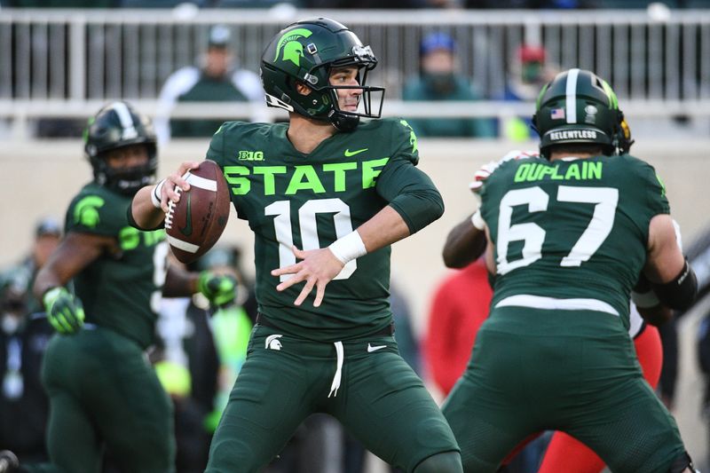 Nov 13, 2021; East Lansing, Michigan, USA; Michigan State Spartans quarterback Payton Thorne (10) drops back to throw the ball during the first quarter against the Maryland Terrapins at Spartan Stadium. Mandatory Credit: Tim Fuller-USA TODAY Sports