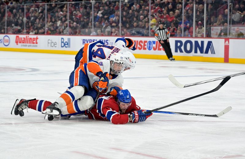 Jan 25, 2024; Montreal, Quebec, CAN; New York Islanders defenseman Alexander Romanov (28) and teammate forward Bo Horvat (14) fall on Montreal Canadiens forward Josh Anderson (17) during the third period at the Bell Centre. Mandatory Credit: Eric Bolte-USA TODAY Sports