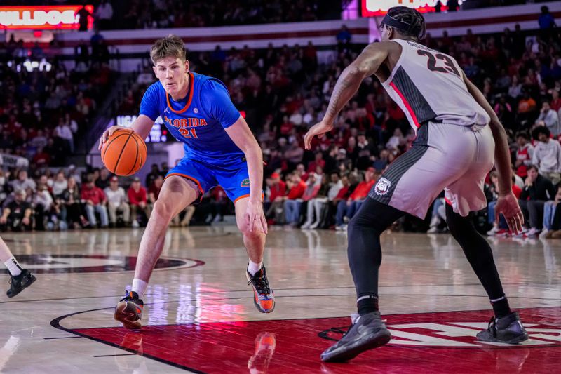 Feb 17, 2024; Athens, Georgia, USA; Florida Gators forward Alex Condon (21) dribbles against Georgia Bulldogs forward Jalen DeLoach (23) during the second half at Stegeman Coliseum. Mandatory Credit: Dale Zanine-USA TODAY Sports