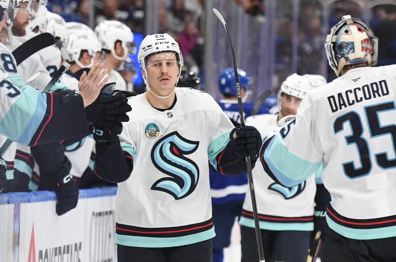 Oct 31, 2024; Toronto, Ontario, CAN;  Seattle Kraken forward Eeli Tolvanen (20) celebrates with team mates after scoring a goal against the Toronto Maple Leafs in the third period at Scotiabank Arena. Mandatory Credit: Dan Hamilton-Imagn Images