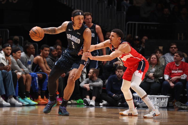 WASHINGTON, DC -? MARCH 6:  Johnny Davis #1 of the Washington Wizards plays defense during the game  against Paolo Banchero #5 of the Orlando Magic on March 6, 2024 at Capital One Arena in Washington, DC. NOTE TO USER: User expressly acknowledges and agrees that, by downloading and or using this Photograph, user is consenting to the terms and conditions of the Getty Images License Agreement. Mandatory Copyright Notice: Copyright 2024 NBAE (Photo by Stephen Gosling/NBAE via Getty Images)