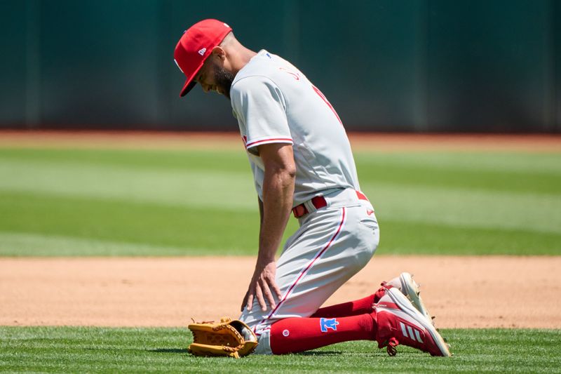 Jun 17, 2023; Oakland, California, USA; Philadelphia Phillies pitcher Cristopher Sanchez (61) reacts after being struck in the pitching hand by a batted ball against the Oakland Athletics during the fourth inning at Oakland-Alameda County Coliseum. Mandatory Credit: Robert Edwards-USA TODAY Sports