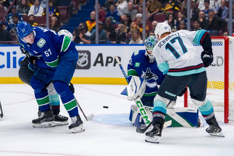 Sep 24, 2024; Vancouver, British Columbia, CAN;  Seattle Kraken forward Jaden Schwartz (17) and Vancouver Canucks defenseman Tyler Myers (57) watch as goalie Arturs Silovs (31) makes a save during the second period at Rogers Arena. Mandatory Credit: Bob Frid-Imagn Images