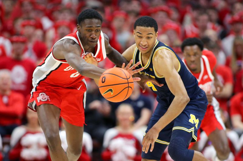 Mar 3, 2024; Columbus, Ohio, USA;  Ohio State Buckeyes guard Scotty Middleton (0) and Michigan Wolverines guard Nimari Burnett (4) go after the loose ball during the second half at Value City Arena. Mandatory Credit: Joseph Maiorana-USA TODAY Sports