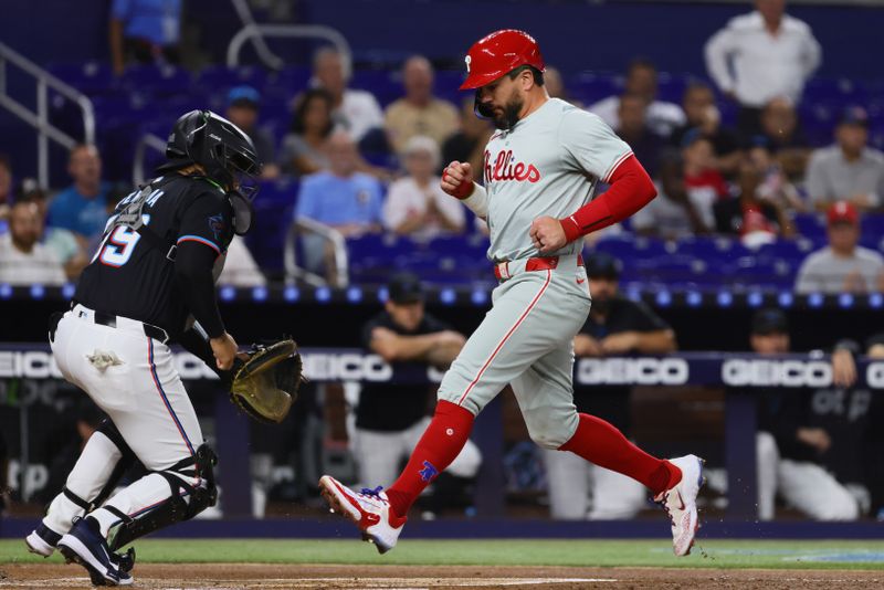 Sep 6, 2024; Miami, Florida, USA; Philadelphia Phillies designated hitter Kyle Schwarber (12) scores after an RBI single by first baseman Bryce Harper (not pictured) during the first inning at loanDepot Park. Mandatory Credit: Sam Navarro-Imagn Images