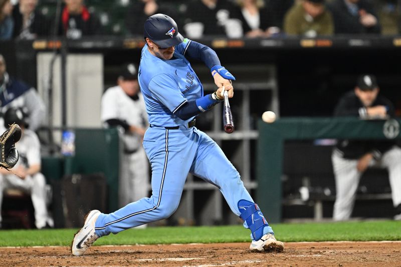 May 28, 2024; Chicago, Illinois, USA;  Toronto Blue Jays catcher Danny Jansen (9) hits a single in the fifth inning against the Chicago White Sox at Guaranteed Rate Field. Mandatory Credit: Jamie Sabau-USA TODAY Sports