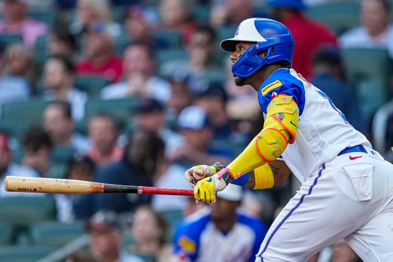 Jul 29, 2023; Cumberland, Georgia, USA; Atlanta Braves right fielder Ronald Acuna Jr. (13) watches after hitting a single against the Milwaukee Brewers during the first inning at Truist Park. Mandatory Credit: Dale Zanine-USA TODAY Sports