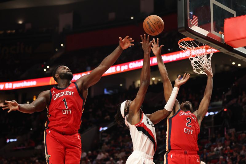 PORTLAND, OREGON - OCTOBER 27: Jerami Grant #9 of the Portland Trail Blazers drives to the basket as Zion Williamson #1, left, and Herbert Jones #2 of the New Orleans Pelicans defend during the fourth quarter at Moda Center on October 27, 2024 in Portland, Oregon. NOTE TO USER: User expressly acknowledges and agrees that, by downloading and or using this photograph, User is consenting to the terms and conditions of the Getty Images License Agreement.? (Photo by Amanda Loman/Getty Images)