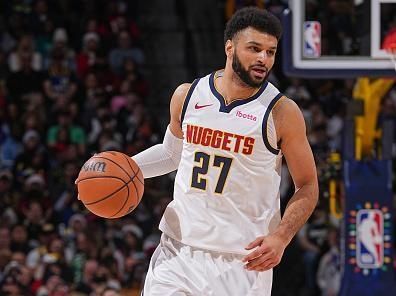 DENVER, CO - DECEMBER 25: Jamal Murray #27 of the Denver Nuggets brings the ball up court against the Golden State Warriors on December 25, 2023 at the Ball Arena in Denver, Colorado. NOTE TO USER: User expressly acknowledges and agrees that, by downloading and/or using this Photograph, user is consenting to the terms and conditions of the Getty Images License Agreement. Mandatory Copyright Notice: Copyright 2023 NBAE (Photo by Bart Young/NBAE via Getty Images)