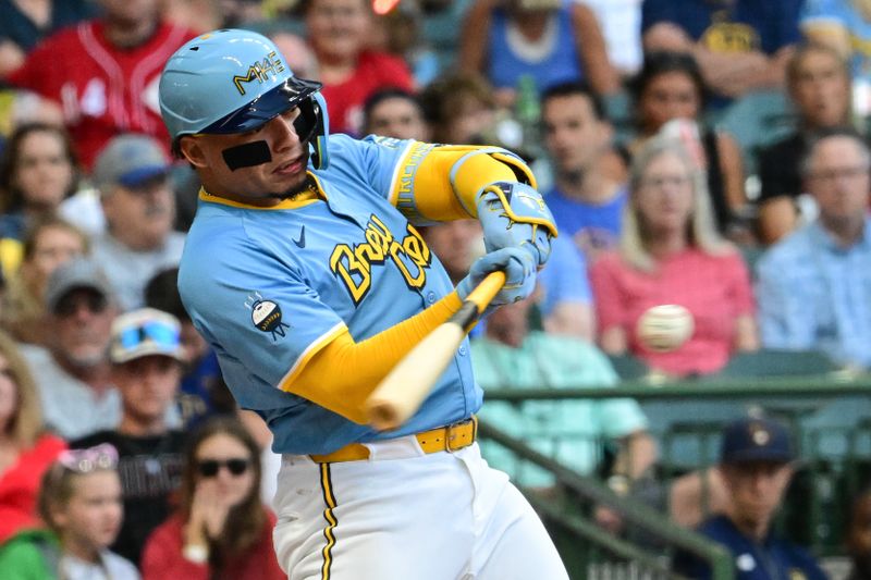 Jun 14, 2024; Milwaukee, Wisconsin, USA; Milwaukee Brewers  catcher William Contreras (24) hits a single in the first inning against the Cincinnati Reds at American Family Field. Mandatory Credit: Benny Sieu-USA TODAY Sports