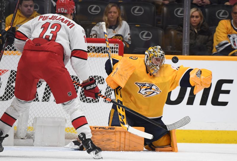 Apr 6, 2023; Nashville, Tennessee, USA; Nashville Predators goaltender Juuse Saros (74) makes a save during the first period against the Carolina Hurricanes at Bridgestone Arena. Mandatory Credit: Christopher Hanewinckel-USA TODAY Sports