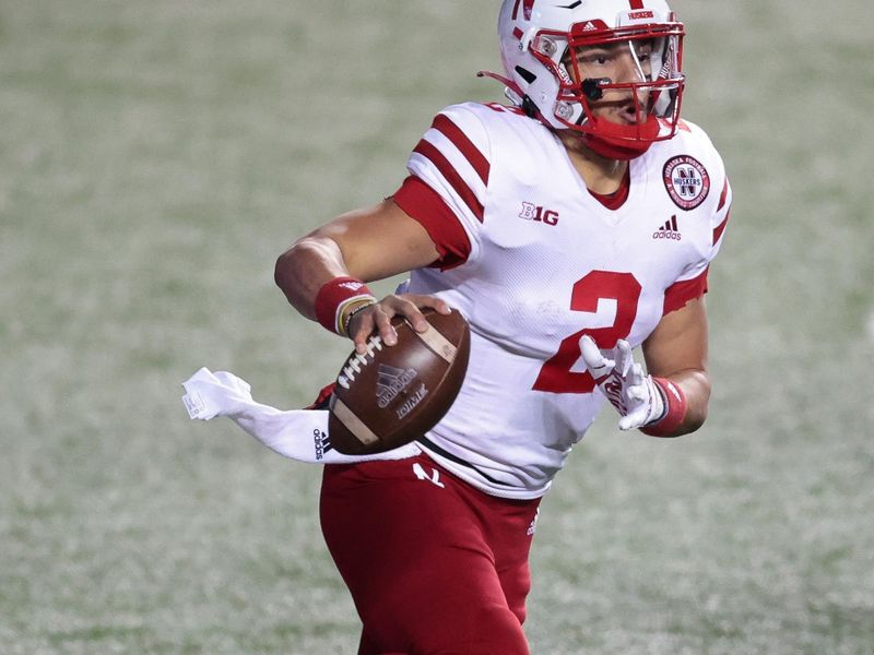 Dec 18, 2020; Piscataway, New Jersey, USA; Nebraska Cornhuskers quarterback Adrian Martinez (2) scrambles during the first half against the Rutgers Scarlet Knights at SHI Stadium. Mandatory Credit: Vincent Carchietta-USA TODAY Sports