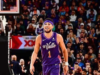 PHOENIX, AZ - DECEMBER 29: Devin Booker #1 of the Phoenix Suns smiles during the game against the Charlotte Hornets on December 29 2023 at Footprint Center in Phoenix, Arizona. NOTE TO USER: User expressly acknowledges and agrees that, by downloading and or using this photograph, user is consenting to the terms and conditions of the Getty Images License Agreement. Mandatory Copyright Notice: Copyright 2023 NBAE (Photo by Barry Gossage/NBAE via Getty Images)