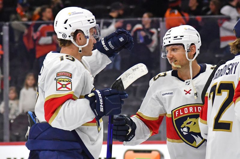 Mar 24, 2024; Philadelphia, Pennsylvania, USA; Florida Panthers left wing Matthew Tkachuk (19) and center Sam Reinhart (13) celebrate win against the Philadelphia Flyers at Wells Fargo Center. Mandatory Credit: Eric Hartline-USA TODAY Sports