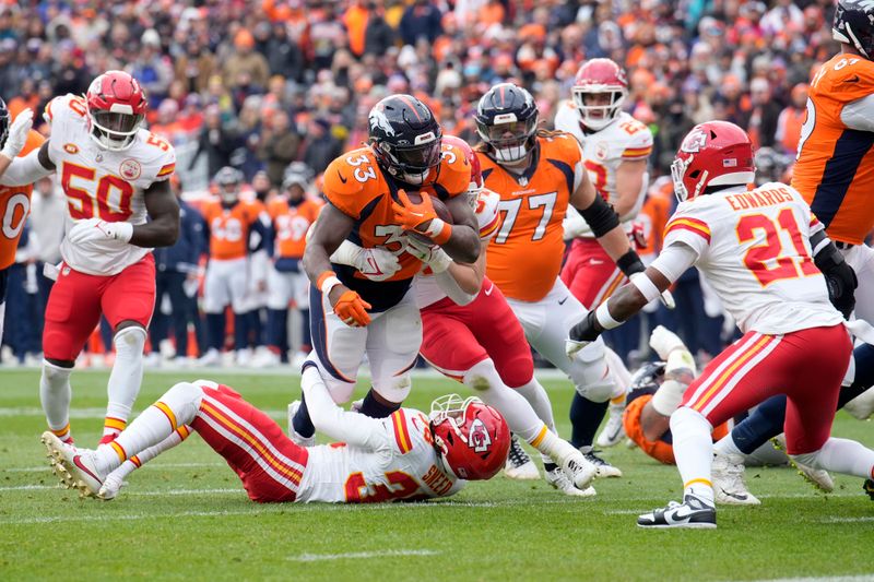 Denver Broncos running back Javonte Williams (33) runs with the ball during the first half of an NFL football game against the Kansas City Chiefs Sunday, Oct. 29, 2023, in Denver. (AP Photo/David Zalubowski)