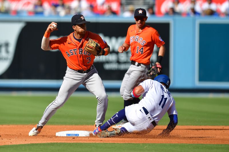 Jun 25, 2023; Los Angeles, California, USA; Los Angeles Dodgers shortstop Miguel Rojas (11) is out at second as Houston Astros shortstop Jeremy Pena (3) throws to first during the third inning at Dodger Stadium. Mandatory Credit: Gary A. Vasquez-USA TODAY Sports