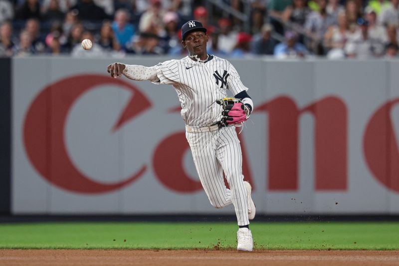 Aug 30, 2024; Bronx, New York, USA;  New York Yankees third baseman Jazz Chisholm Jr. (13) throws the ball to first base for an out during the seventh inning against the St. Louis Cardinals at Yankee Stadium. Mandatory Credit: Vincent Carchietta-USA TODAY Sports