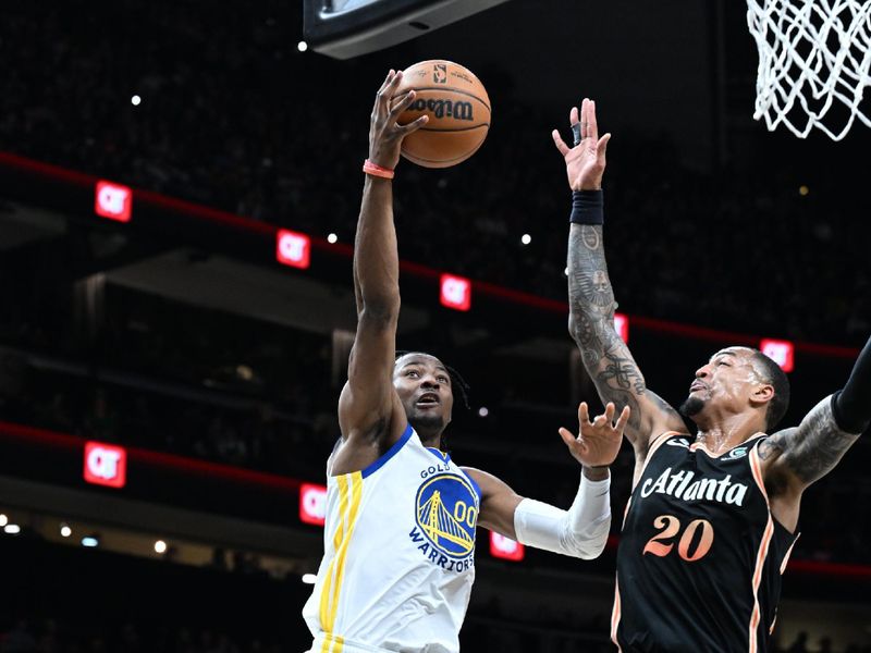 ATLANTA, GA - MARCH 17: Jonathan Kuminga #00 of the Golden State Warriors drives to the basket during the game against the Atlanta Hawks on March 17, 2023 at State Farm Arena in Atlanta, Georgia.  NOTE TO USER: User expressly acknowledges and agrees that, by downloading and/or using this Photograph, user is consenting to the terms and conditions of the Getty Images License Agreement. Mandatory Copyright Notice: Copyright 2023 NBAE (Photo by Adam Hagy/NBAE via Getty Images)