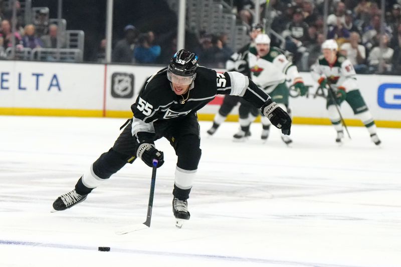 Apr 15, 2024; Los Angeles, California, USA; LA Kings right wing Quinton Byfield (55) skates with the puck against the Minnesota Wild in the second period at Crypto.com Arena. Mandatory Credit: Kirby Lee-USA TODAY Sports