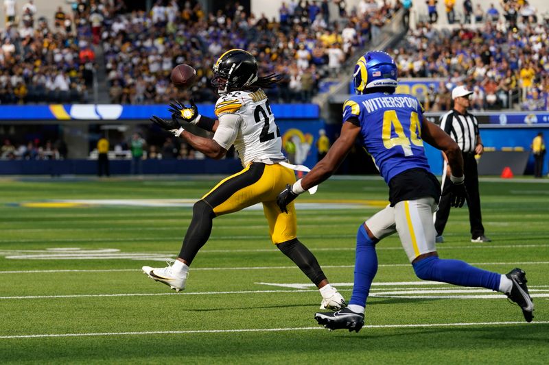 Pittsburgh Steelers running back Najee Harris, left, makes a catch as Los Angeles Rams cornerback Ahkello Witherspoon defends during the second half of an NFL football game Sunday, Oct. 22, 2023, in Inglewood, Calif. (AP Photo/Gregory Bull)