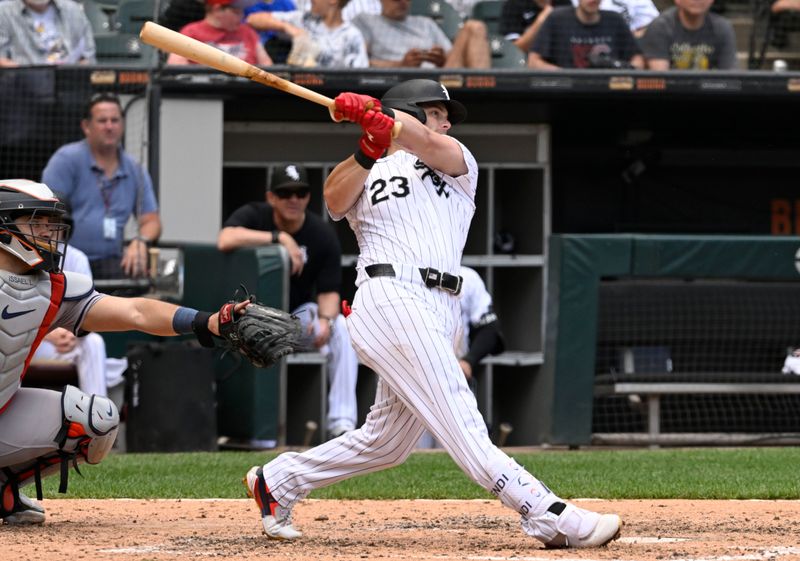 Jun 20, 2024; Chicago, Illinois, USA;  Chicago White Sox outfielder Andrew Benintendi (23) hits an RBI sacrifice fly ball against the Houston Astros during the fifth inning at Guaranteed Rate Field. Mandatory Credit: Matt Marton-USA TODAY Sports