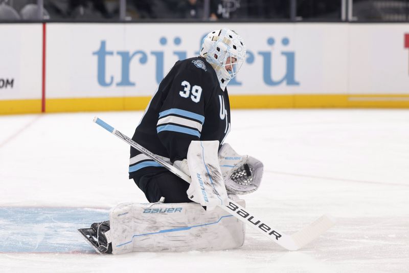 Oct 28, 2024; Salt Lake City, Utah, USA; Utah Hockey Club goaltender Connor Ingram (39) catches the puck before the game against the San Jose Sharks at Delta Center. Mandatory Credit: Chris Nicoll-Imagn Images